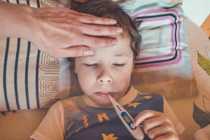 child getting temperature taken
